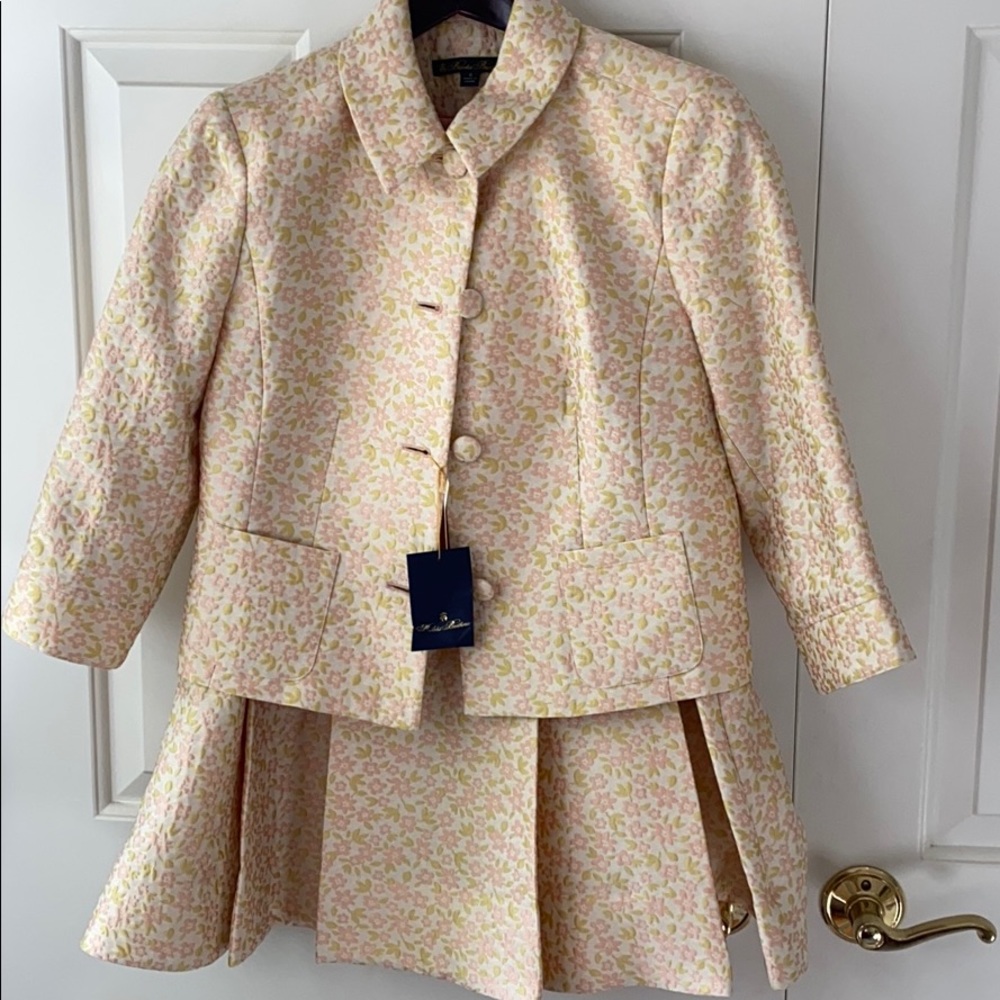 Cream suit with pail pink flowers and lime leaves